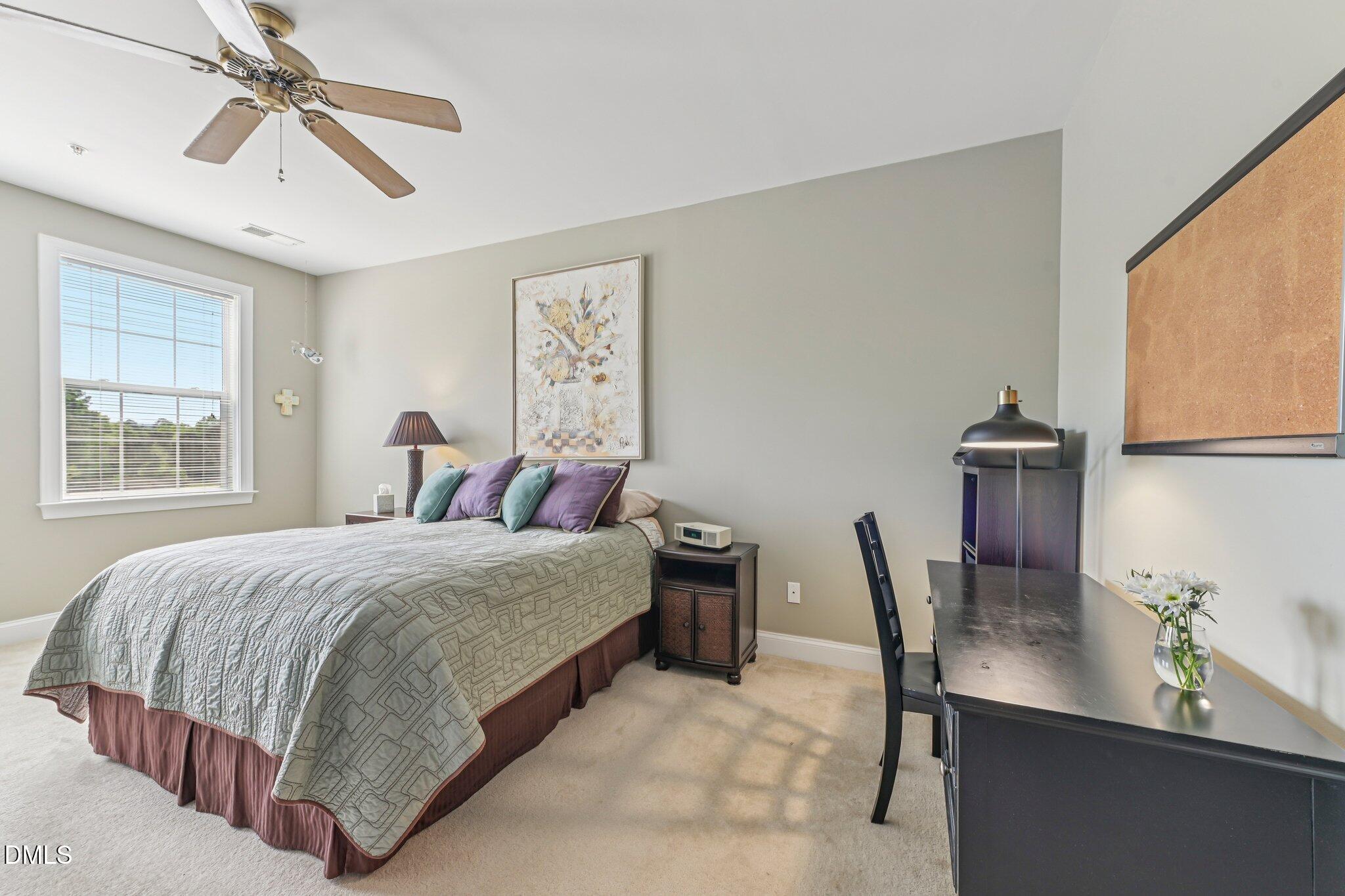 10411 Rosegate Court, Unit 205 Raleigh, NC 27617 - Photo 21 of 38 a bedroom with a bed a computer on the desk and chair