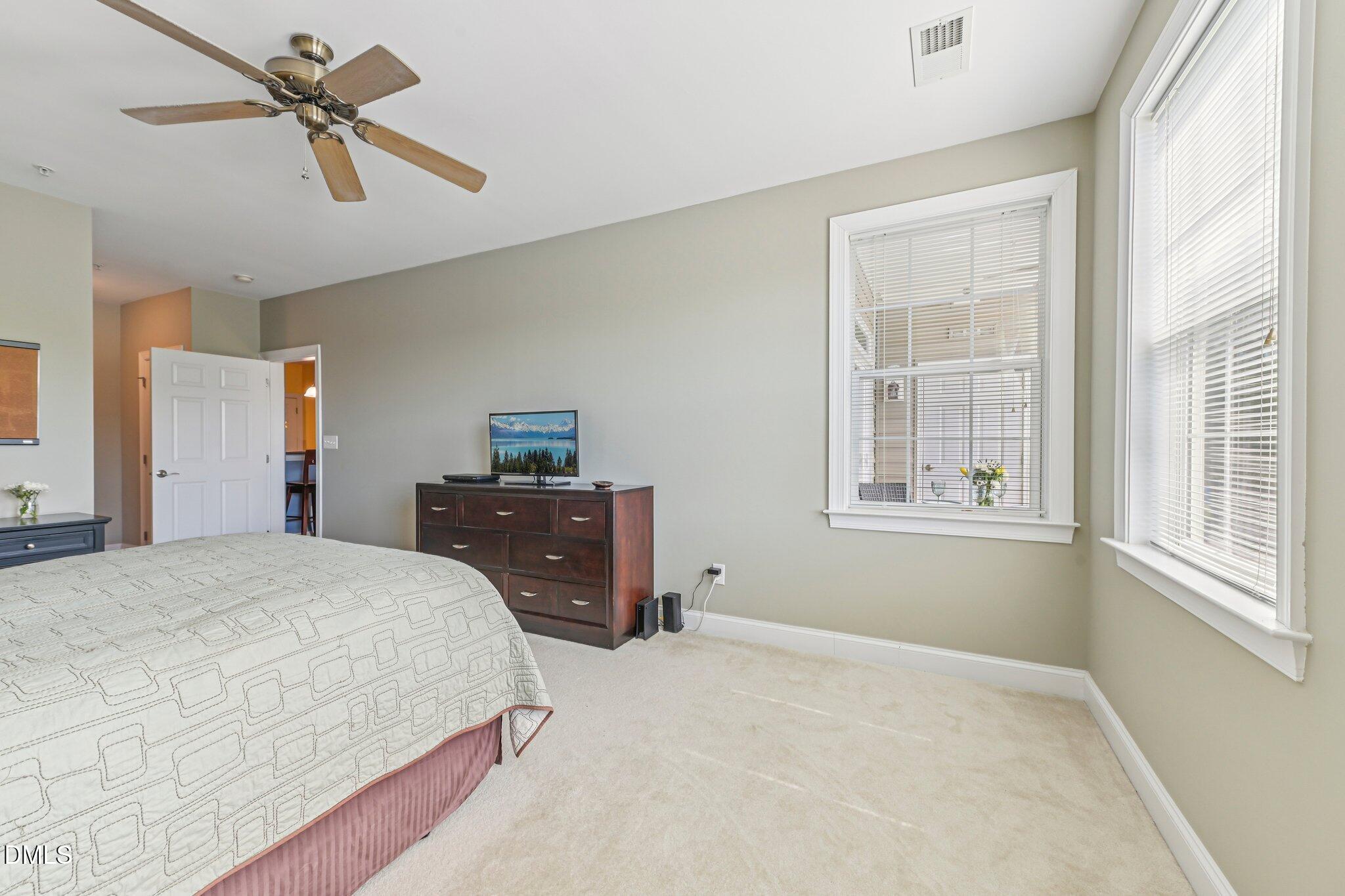 10411 Rosegate Court, Unit 205 Raleigh, NC 27617 - Photo 22 of 38 a bedroom with a bed dresser and a window