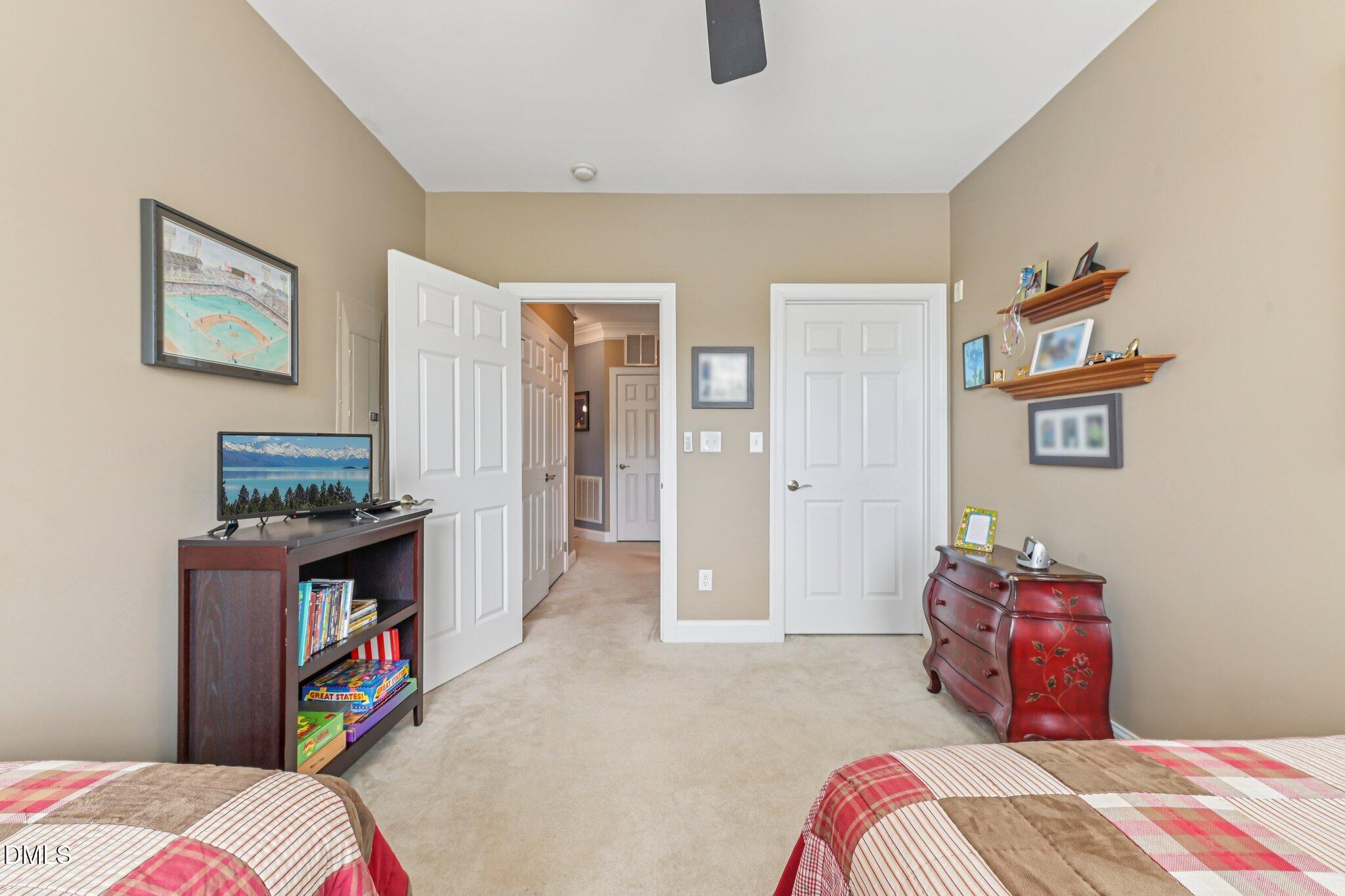 10411 Rosegate Court, Unit 205 Raleigh, NC 27617 - Photo 23 of 38 a bedroom with a bed and a cabinets