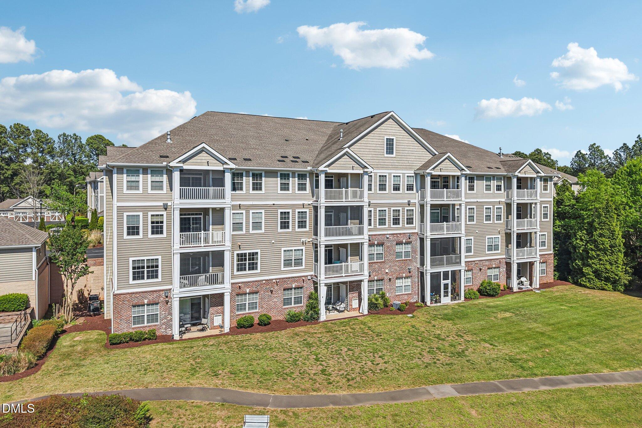 10411 Rosegate Court, Unit 205 Raleigh, NC 27617 - Photo 36 of 38 a view of a large building with a big yard and large trees