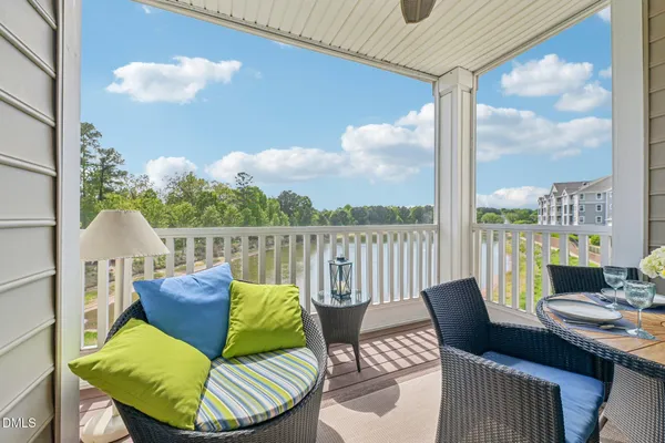 a roof deck with couches and potted plants