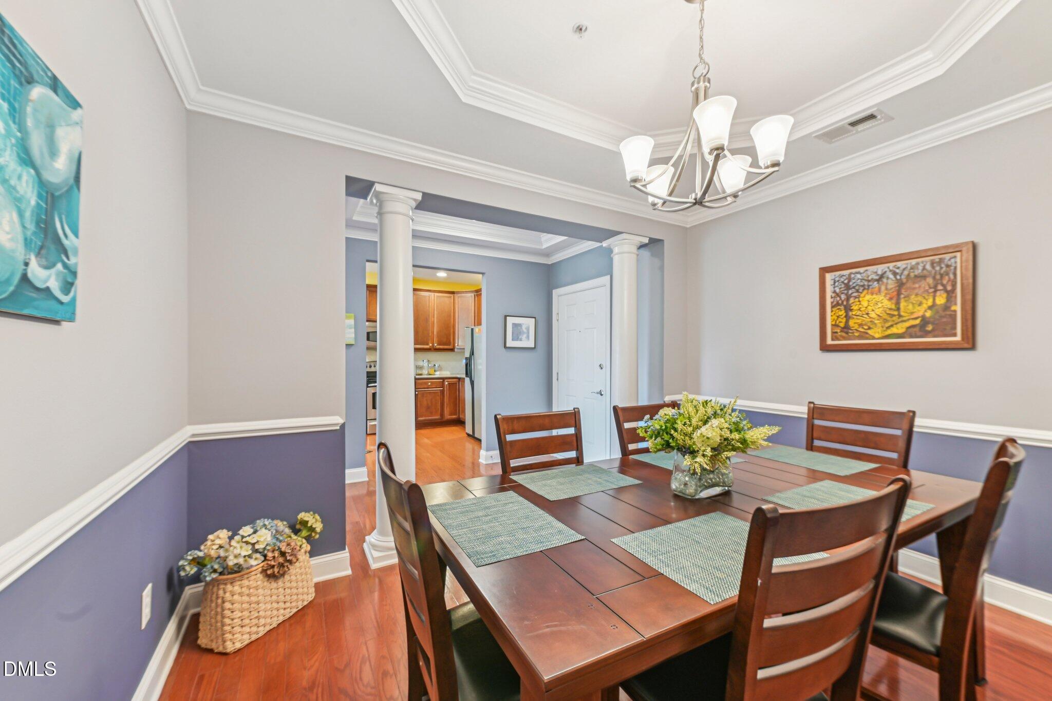 10411 Rosegate Court, Unit 205 Raleigh, NC 27617 - Photo 6 of 38 a view of a dining room with furniture and chandelier