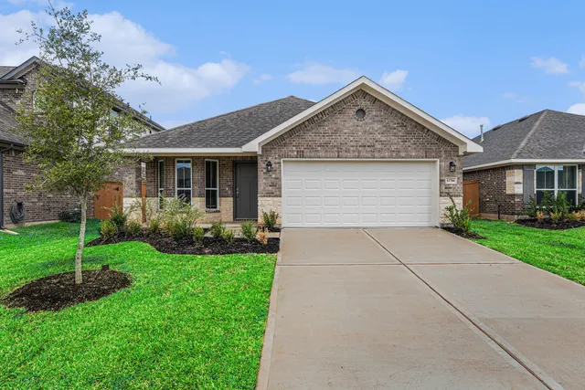 a view of a house with yard and tree s