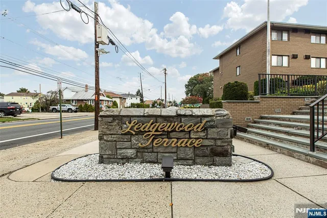 a sign board on the side of a street