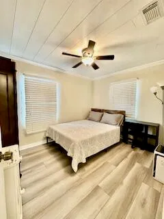 a bedroom with a bed and a ceiling fan