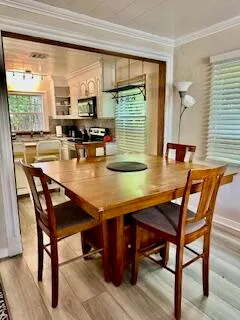 a dining room with furniture and wooden floor