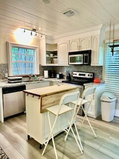 304 Southeast 3rd Avenue Delray Beach, FL 33483 - Photo 8 of 8 a kitchen with a stove a sink and a microwave