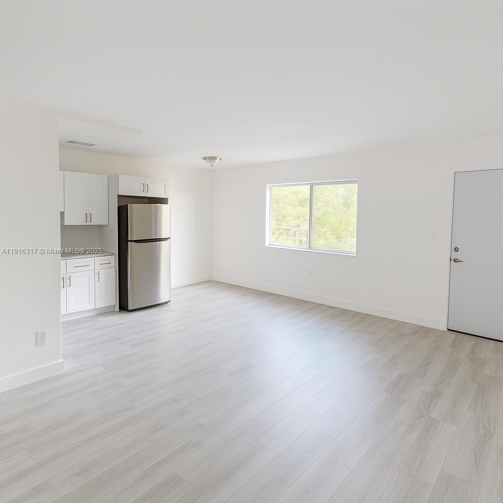 1280 West 54th Street, Unit 322B Hialeah, FL 33012 - Photo 12 of 14 an empty room with windows and closet