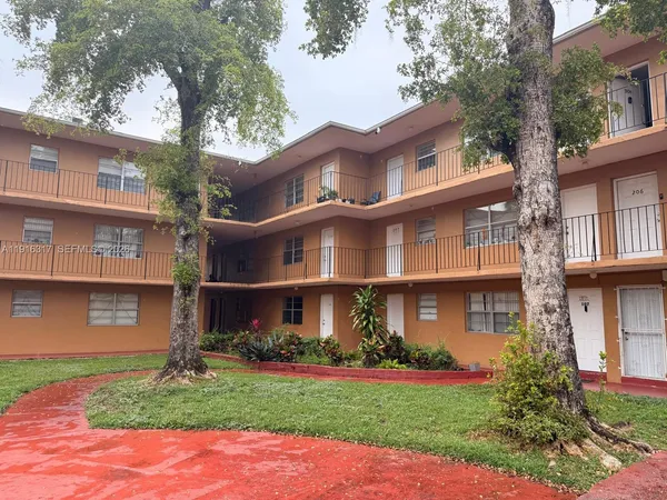 a front view of a residential houses with yard