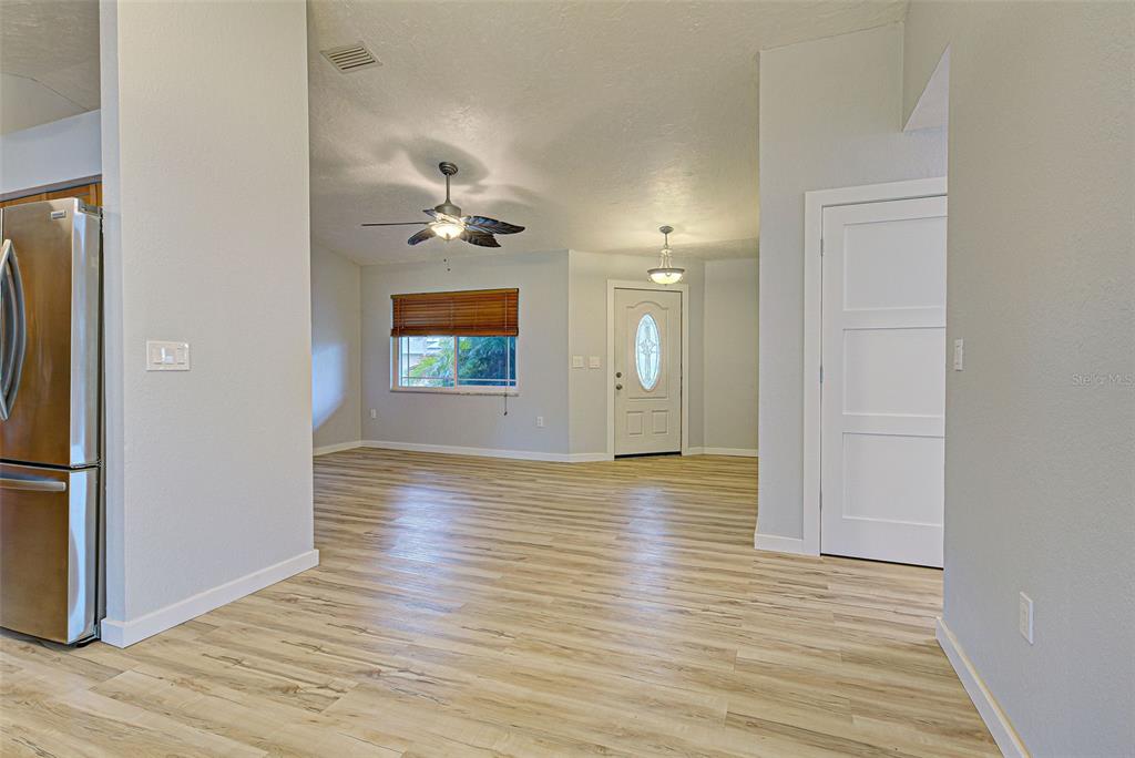 3187 Galiot Road Venice, FL 34293 - Photo 12 of 46 a view of a room with wooden floor and a ceiling fan