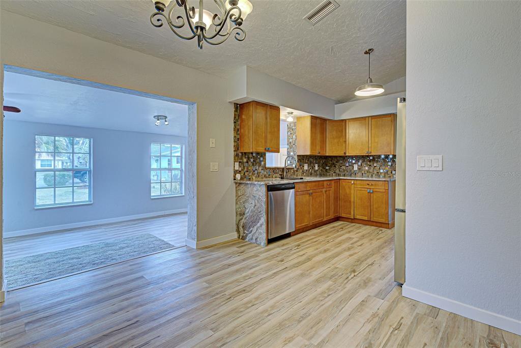 3187 Galiot Road Venice, FL 34293 - Photo 13 of 46 a view of kitchen with wooden floor electronic appliances and window