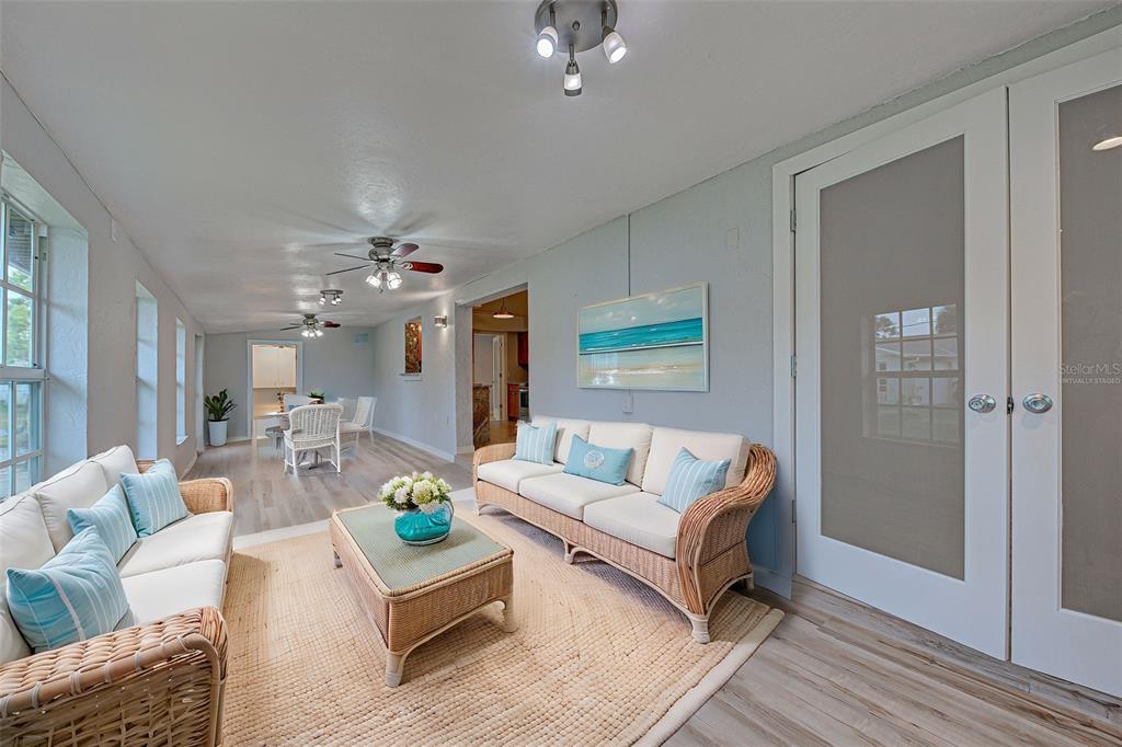 3187 Galiot Road Venice, FL 34293 - Photo 20 of 46 a living room with furniture and a chandelier
