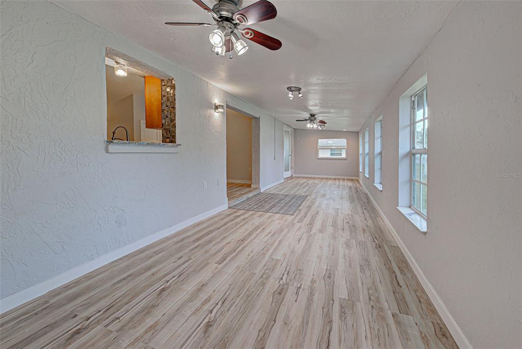 3187 Galiot Road Venice, FL 34293 - Photo 21 of 46 a view of empty room with wooden floor