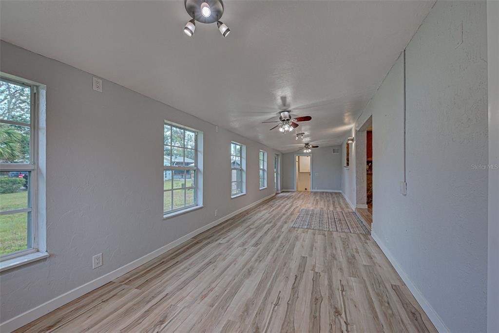 3187 Galiot Road Venice, FL 34293 - Photo 22 of 46 wooden floor in an empty room with a window