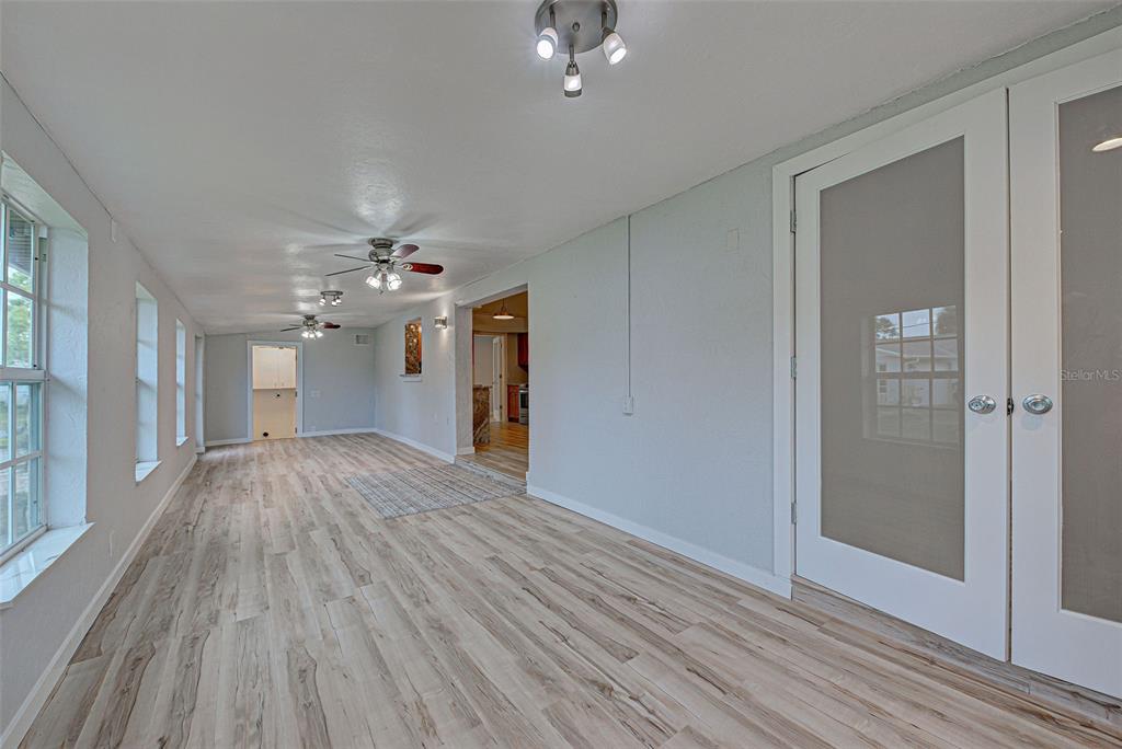 3187 Galiot Road Venice, FL 34293 - Photo 23 of 46 wooden floor in an empty room with a window