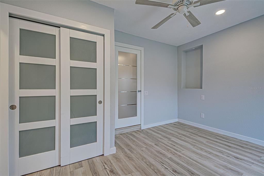 3187 Galiot Road Venice, FL 34293 - Photo 24 of 46 a view of empty room with wooden floor and fan
