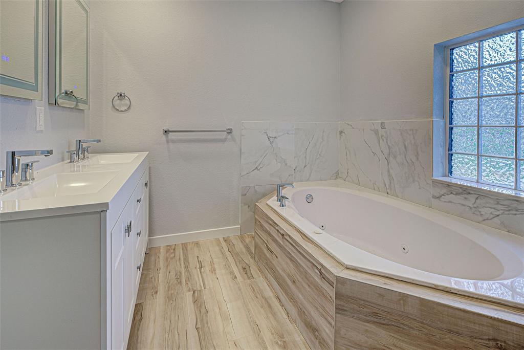 3187 Galiot Road Venice, FL 34293 - Photo 29 of 46 a bathroom with a tub sink and mirror
