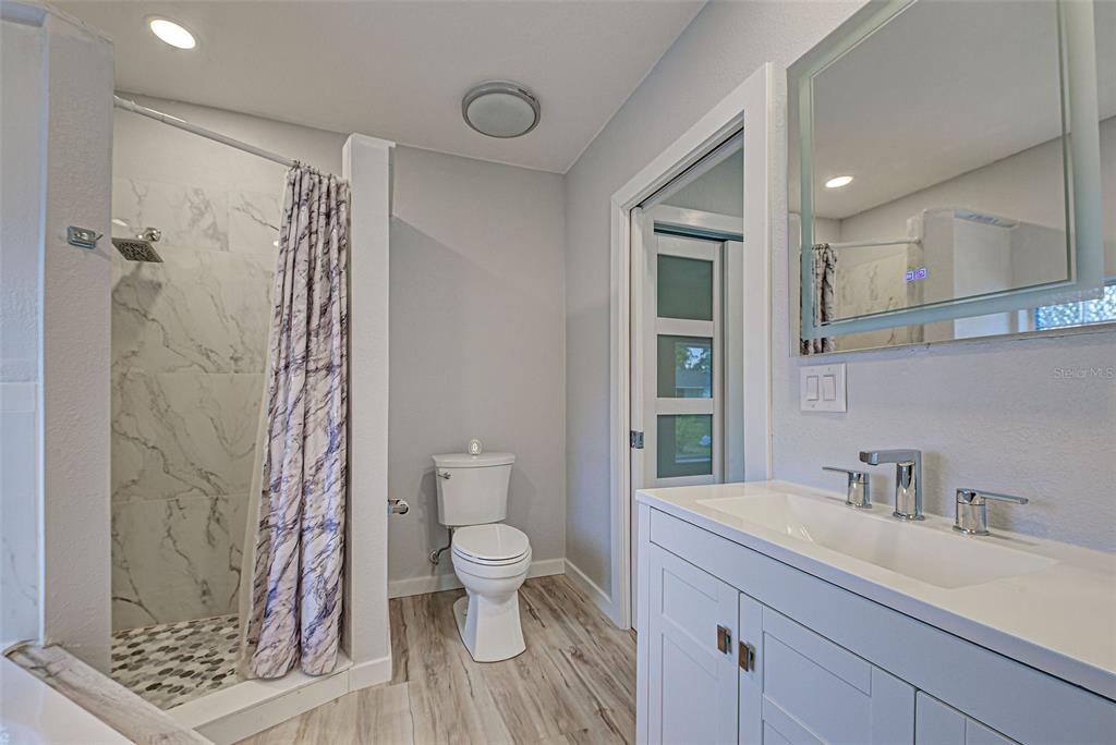 3187 Galiot Road Venice, FL 34293 - Photo 30 of 46 a spacious bathroom with a granite countertop sink a toilet and a shower