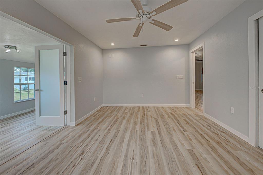 3187 Galiot Road Venice, FL 34293 - Photo 32 of 46 wooden floor in an empty room with a window
