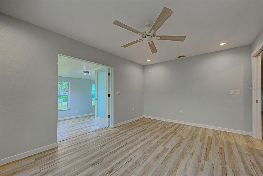 3187 Galiot Road Venice, FL 34293 - Photo 33 of 46 wooden floor in an empty room with a window