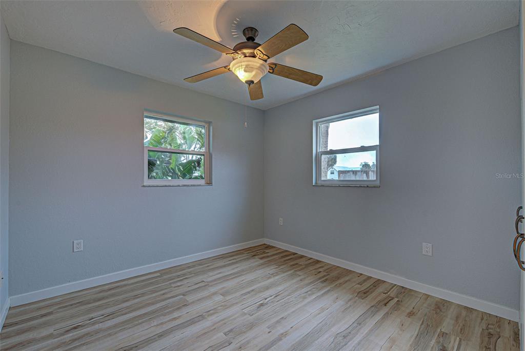 3187 Galiot Road Venice, FL 34293 - Photo 39 of 46 wooden floor in an empty room with a window