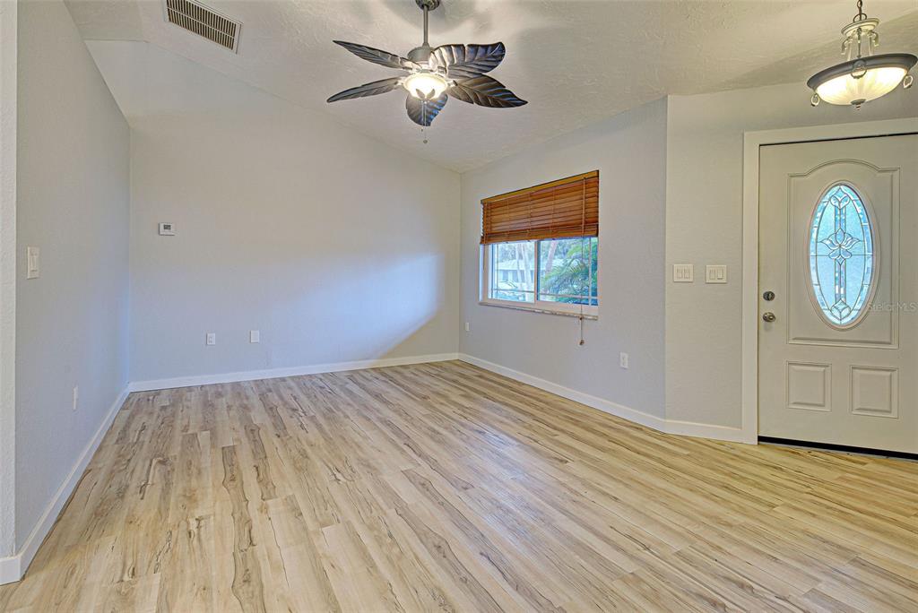 3187 Galiot Road Venice, FL 34293 - Photo 6 of 46 a view of empty room with wooden floor and fan