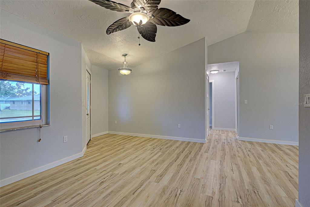 3187 Galiot Road Venice, FL 34293 - Photo 7 of 46 wooden floor in an empty room with a window