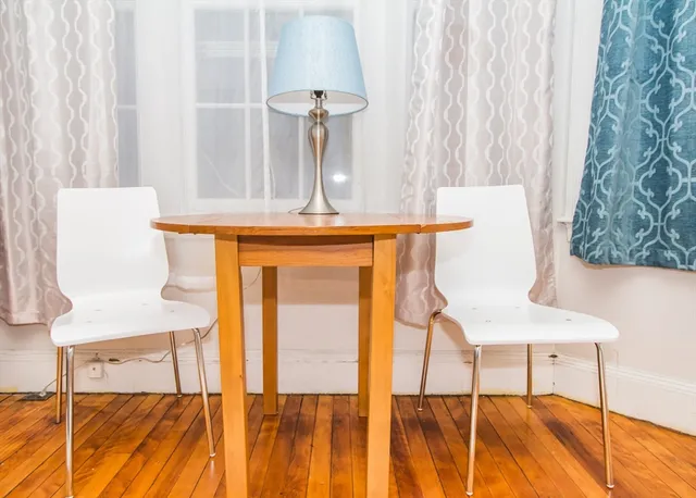 a view of a room with a bed and a chandelier