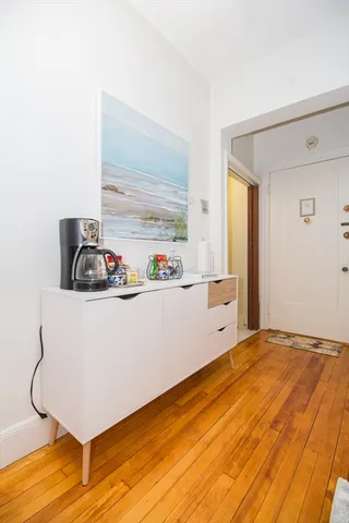 a room with a wooden floor and cabinets