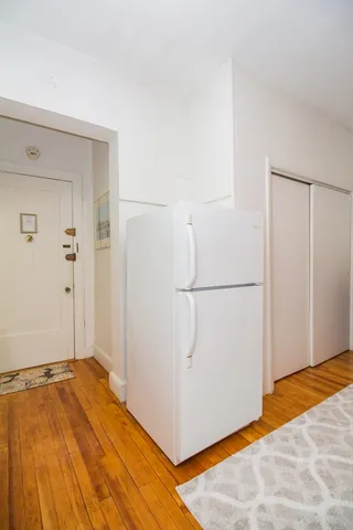 a view of a bedroom with wooden floor