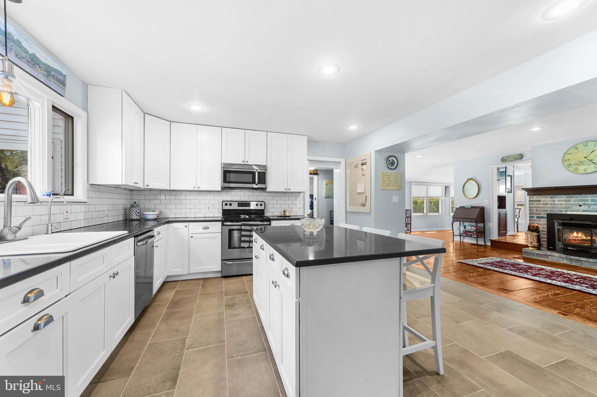 72 Poor Farm Road Pennington, NJ 08534 - Photo 11 of 38 a kitchen with stainless steel appliances granite countertop a sink stove refrigerator and cabinets