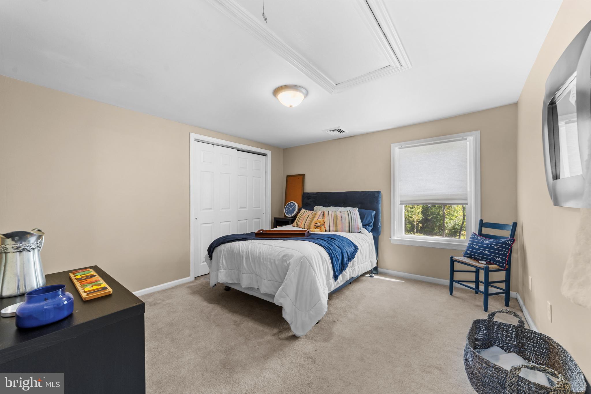 72 Poor Farm Road Pennington, NJ 08534 - Photo 26 of 38 a bedroom with a bed and a couch