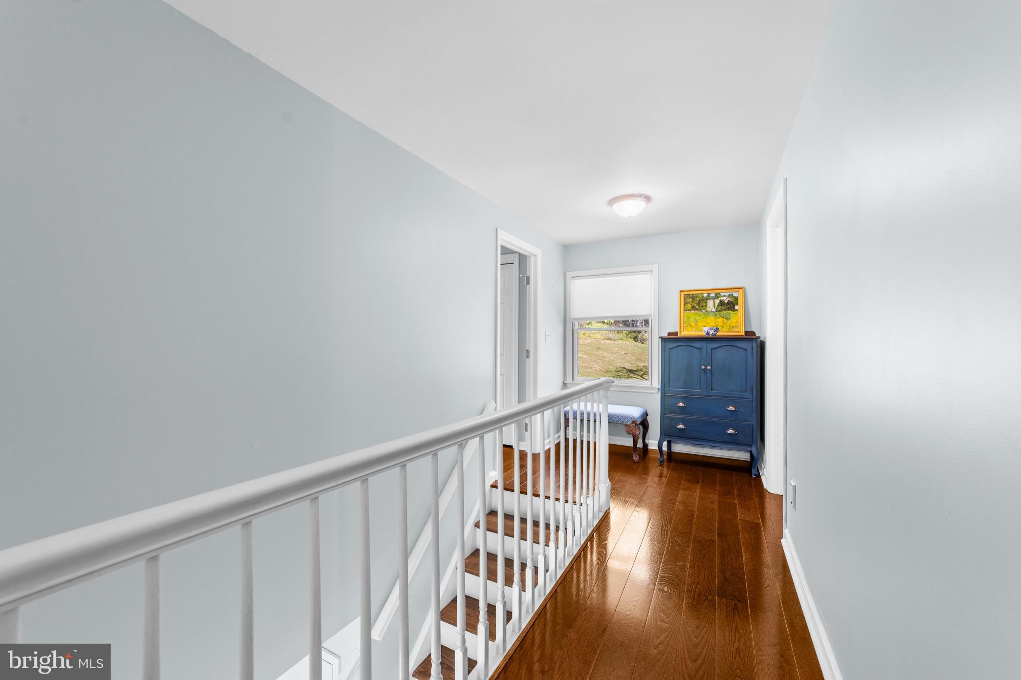 72 Poor Farm Road Pennington, NJ 08534 - Photo 27 of 38 a view of a hallway with wooden floor and stairs
