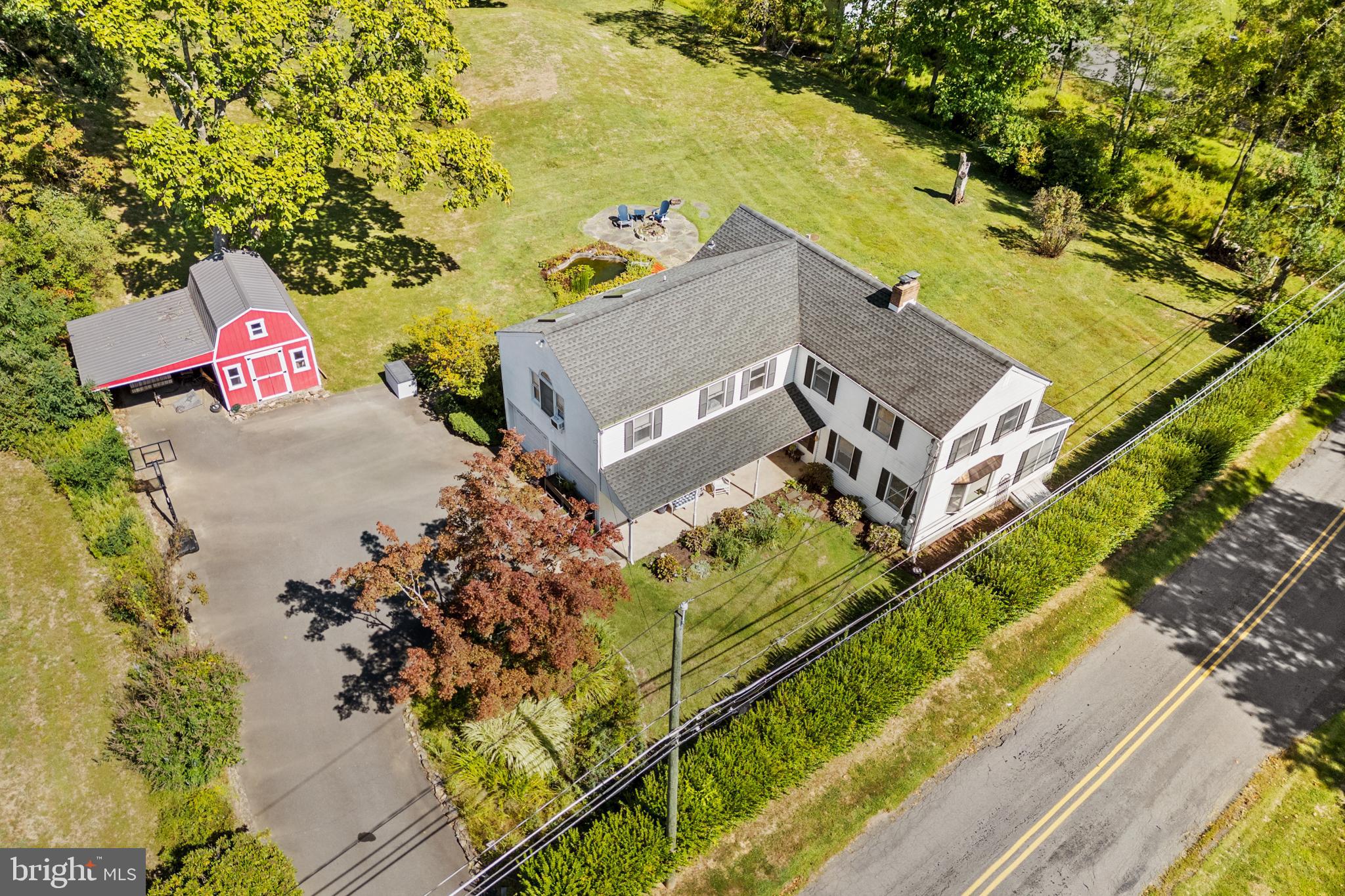 72 Poor Farm Road Pennington, NJ 08534 - Photo 4 of 38 an aerial view of a house with a yard and swimming pool