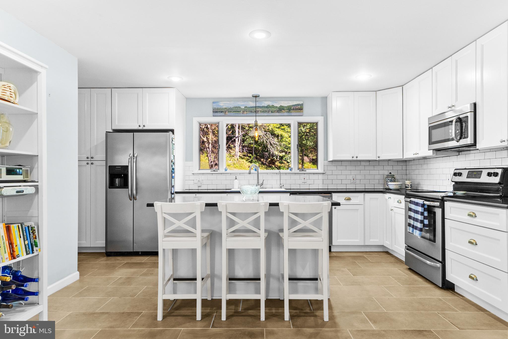 72 Poor Farm Road Pennington, NJ 08534 - Photo 10 of 38 a kitchen with stainless steel appliances granite countertop a stove a sink and a refrigerator