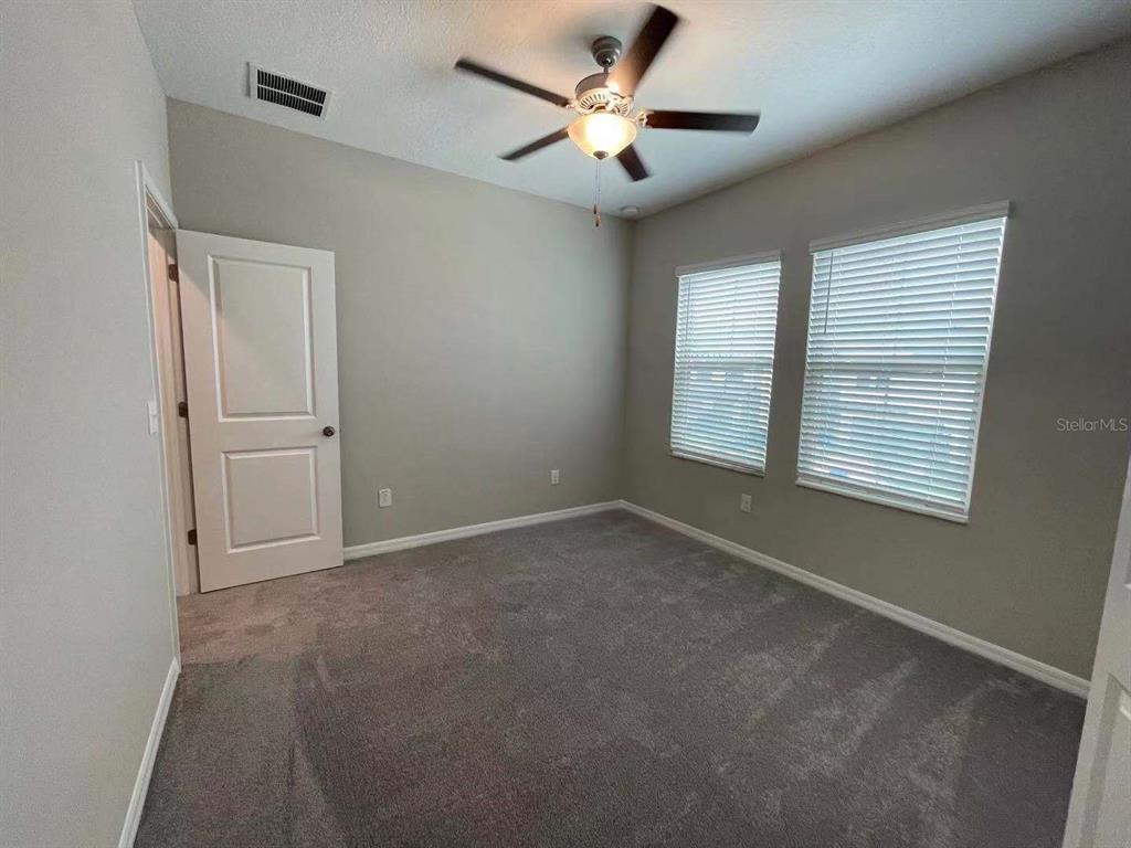31993 Blue Passing Loop Wesley Chapel, FL 33545 - Photo 13 of 17 a view of an empty room with a window
