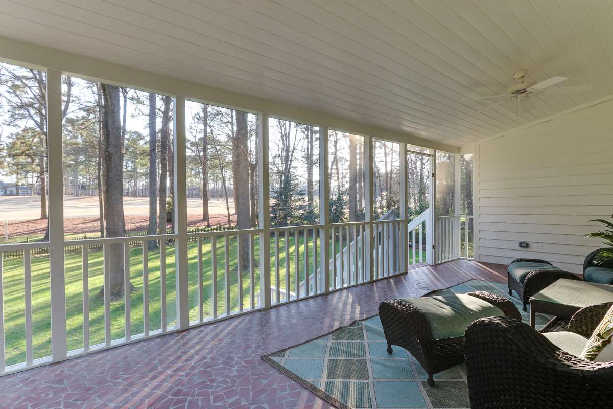 7009 North Ridge Drive Raleigh, NC 27615 - Photo 22 of 25 Large screened porch overlooking backyard with mature trees and golf course. Screened Porch