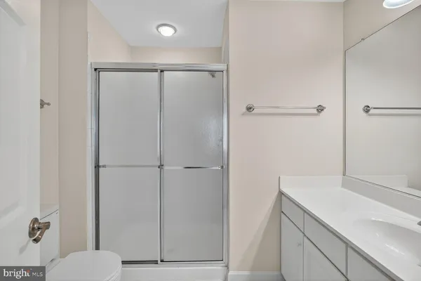 a bathroom with a shower toilet and sink