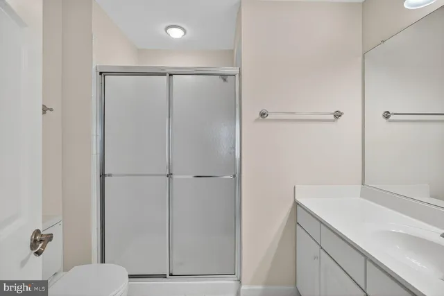 a bathroom with a shower toilet and sink