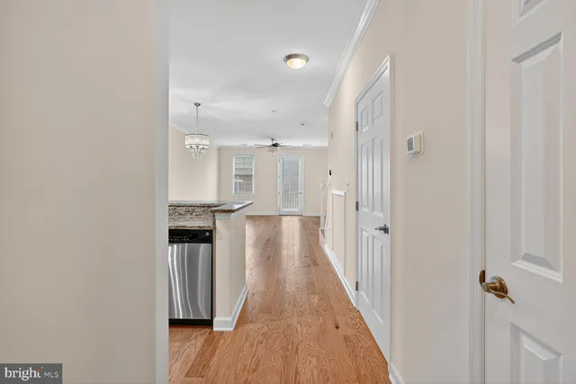 a view of a hallway with wooden floor