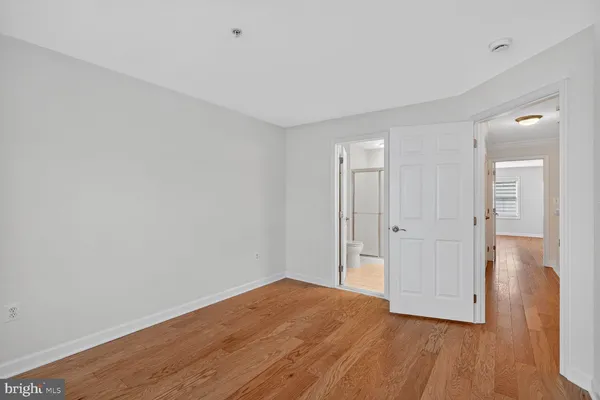 a view of a room with wooden floor and brick walls