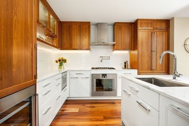 a kitchen with stainless steel appliances granite countertop a sink stove and refrigerator