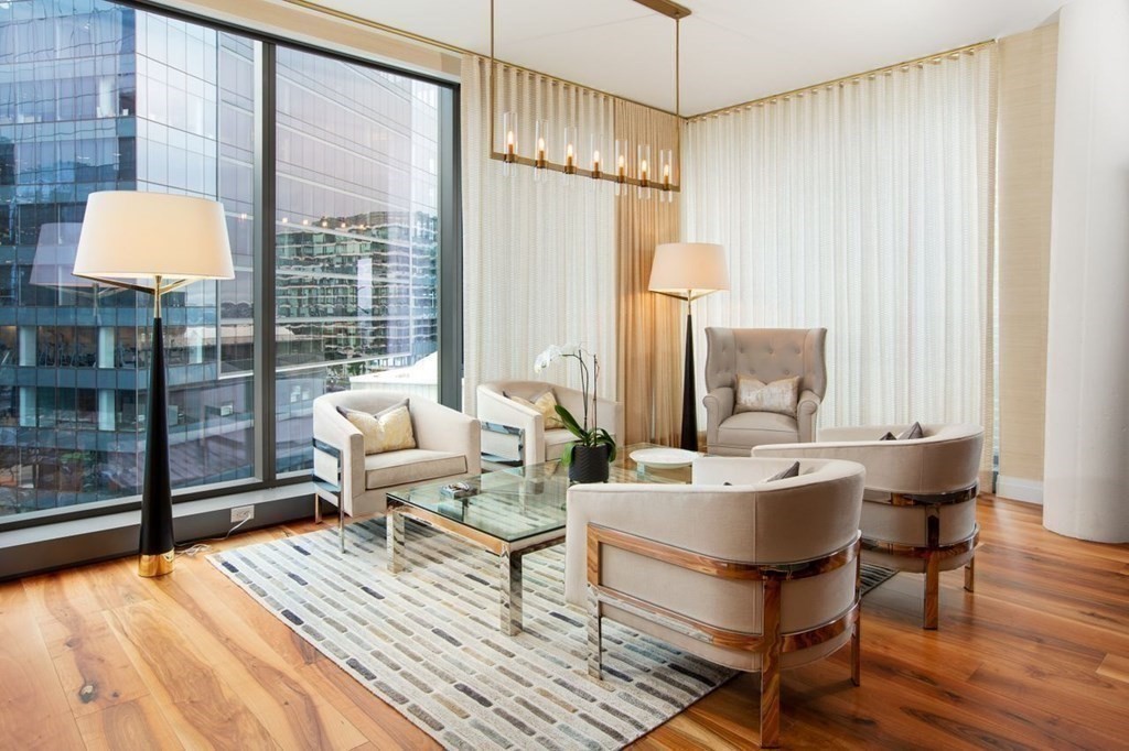 300 Pier 4 Blvd., Unit 8N Boston, MA 02210 - Photo 11 of 37 a living room with furniture a lamp and a table