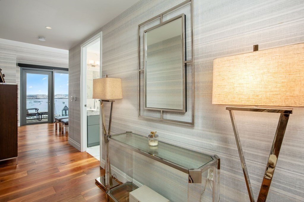 300 Pier 4 Blvd., Unit 8N Boston, MA 02210 - Photo 16 of 37 a bathroom with a sink a mirror and a shower