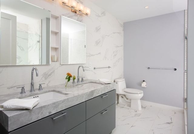 a bathroom with a sink toilet and a mirror