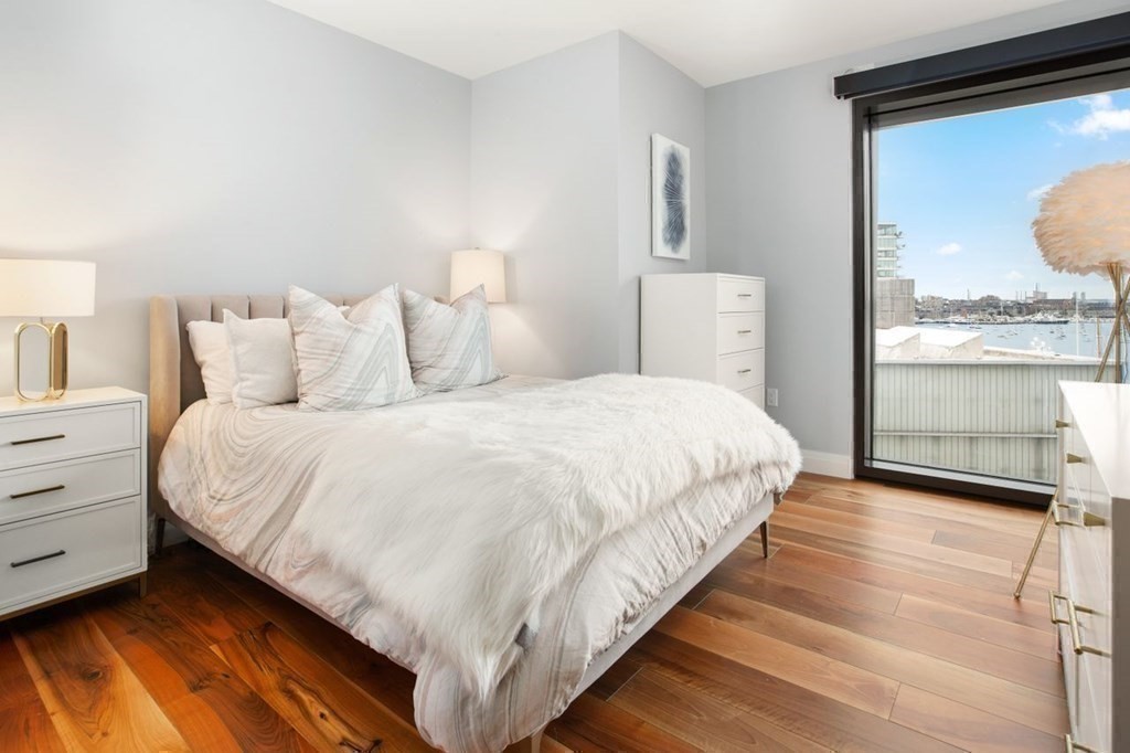 300 Pier 4 Blvd., Unit 8N Boston, MA 02210 - Photo 19 of 37 a large white bed in a white room
