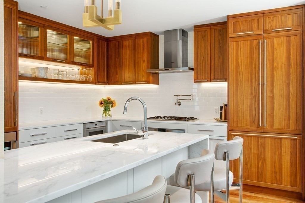 300 Pier 4 Blvd., Unit 8N Boston, MA 02210 - Photo 2 of 37 a kitchen with granite countertop a sink stainless steel appliances and cabinets