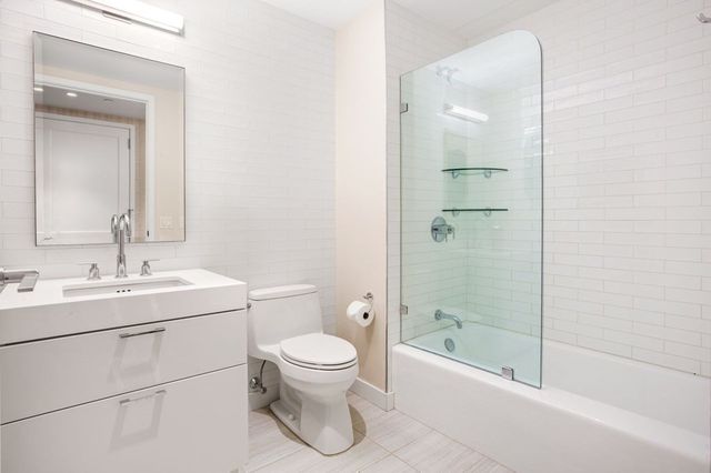 a bathroom with a toilet a sink and shower