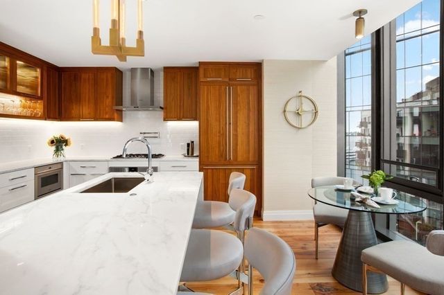 a kitchen with granite countertop a sink and a stove