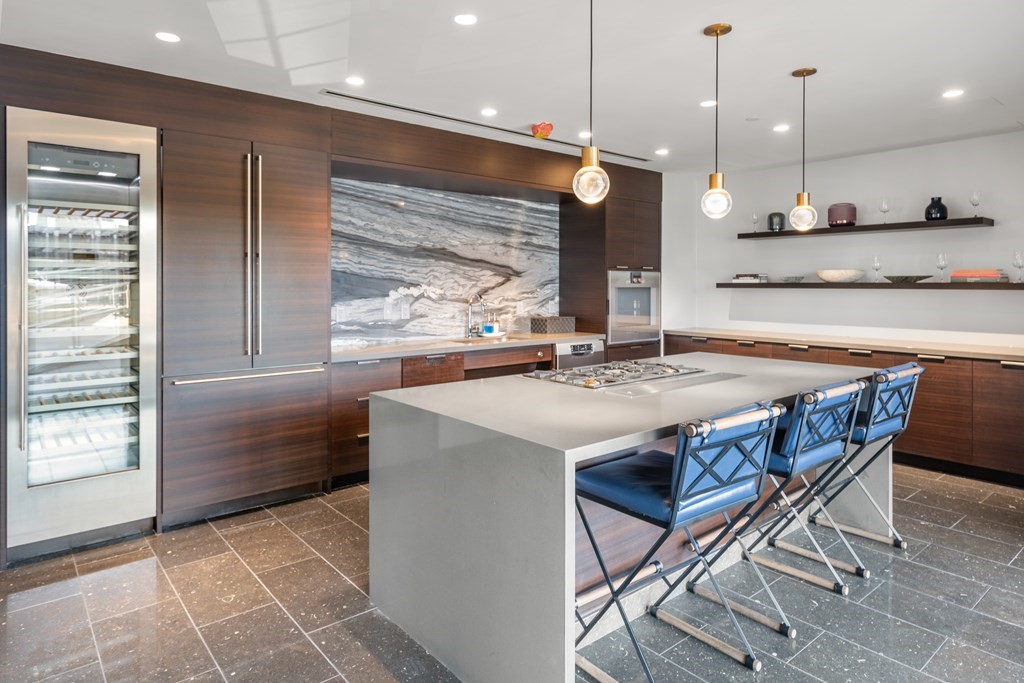 300 Pier 4 Blvd., Unit 8N Boston, MA 02210 - Photo 33 of 37 a kitchen with a table and chairs in it